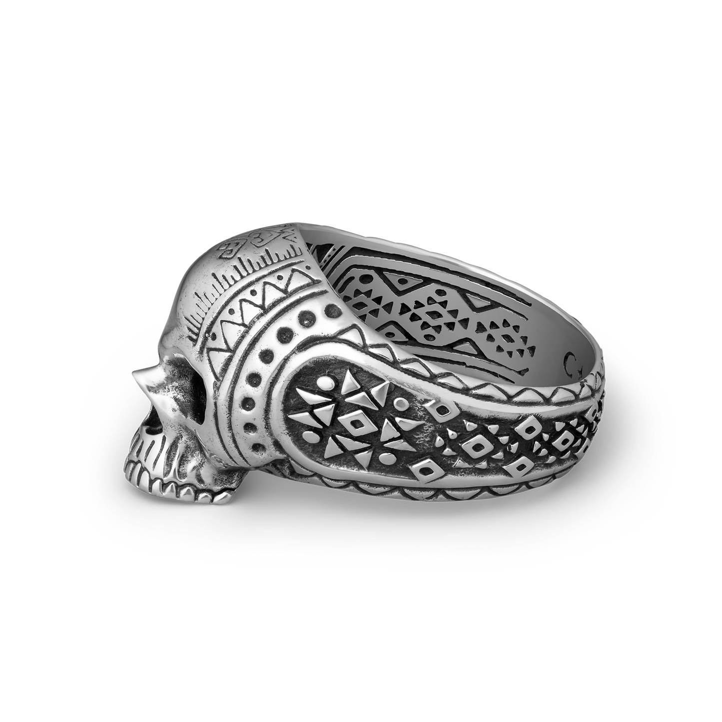 Silver skull ring with intricate patterns on a white background