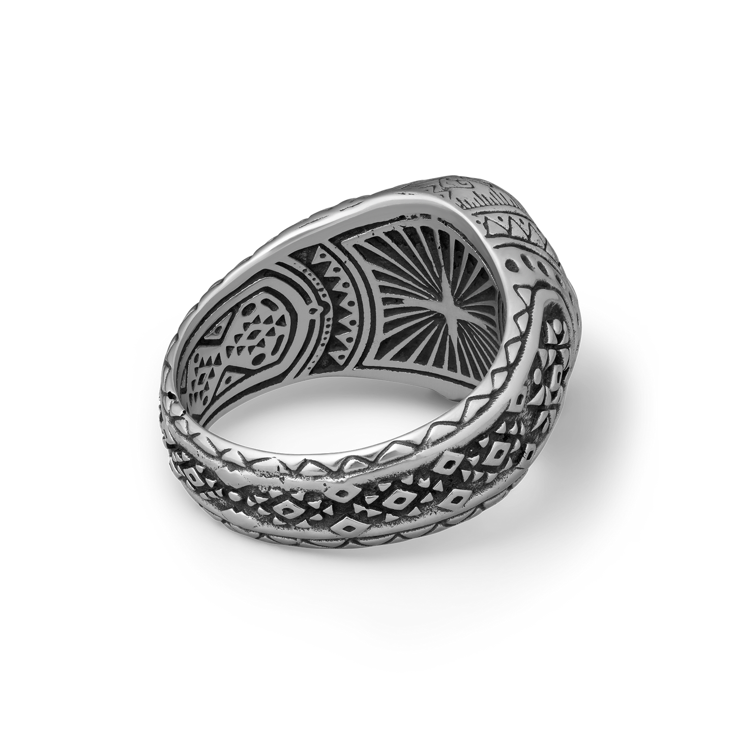 Silver ring with intricate patterns on a white background