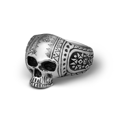 Silver skull ring with intricate patterns on a white background